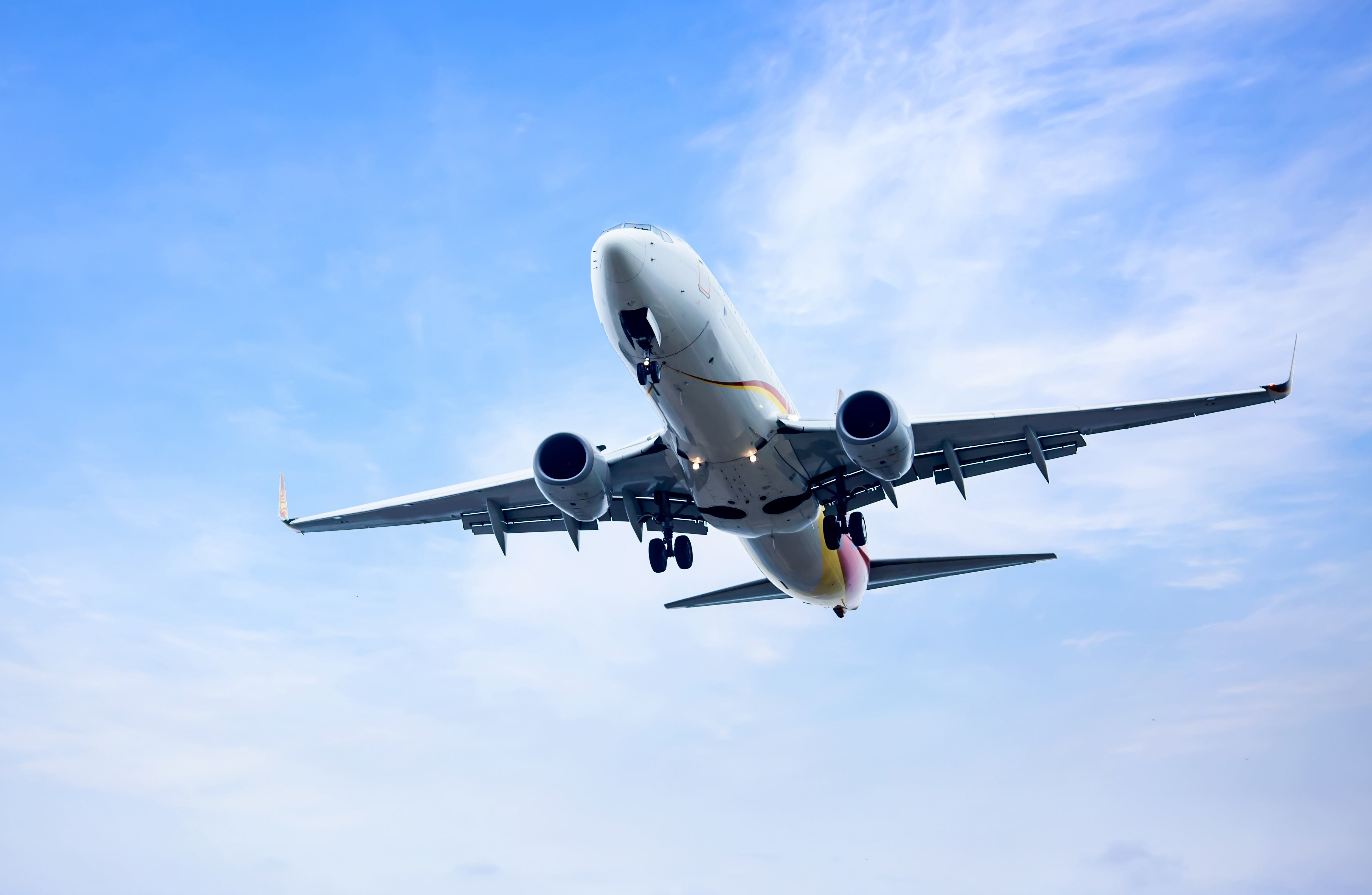 Aircraft soaring through blue skies, symbolizing Rafiki Transportations' growth and commitment to connecting people to their destinations